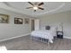 Comfortable bedroom with a tray ceiling, ceiling fan, and neutral decor at 42 Voyage Cir, Smithfield, NC 27577