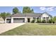 Charming one-story home featuring a three-car garage and landscaped front yard at 42 Voyage Cir, Smithfield, NC 27577