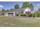 Charming home with a manicured lawn, gray garage door, and elegant exterior features at 42 Voyage Cir, Smithfield, NC 27577