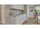 Bright kitchen features granite counters, white cabinets and modern appliances at 42 Voyage Cir, Smithfield, NC 27577