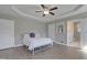 Bright primary bedroom with a tray ceiling and convenient access to the en-suite bathroom at 42 Voyage Cir, Smithfield, NC 27577