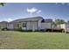 Side view of the house with a well-maintained lawn and a lovely wooden deck, perfect for outdoor enjoyment at 42 Voyage Cir, Smithfield, NC 27577