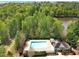 Aerial view of the pool, pool house, and surrounding trees at 421 Gooseberry Dr, Holly Springs, NC 27540