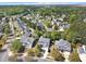 Aerial view of neighborhood with tree-lined streets at 421 Gooseberry Dr, Holly Springs, NC 27540