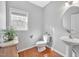 Charming powder room with pedestal sink and window at 421 Gooseberry Dr, Holly Springs, NC 27540