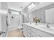 Bright bathroom with double sinks, a large mirror, and a shower/tub combo at 421 Gooseberry Dr, Holly Springs, NC 27540