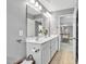 Bathroom featuring a double sink vanity, large mirror, and ceramic tile flooring at 421 Gooseberry Dr, Holly Springs, NC 27540