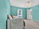 Tranquil bedroom features turquoise walls, a daybed, a bright window, and a fan at 421 Gooseberry Dr, Holly Springs, NC 27540