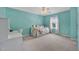 Tranquil bedroom features turquoise walls, a daybed, a bright window, and a fan at 421 Gooseberry Dr, Holly Springs, NC 27540