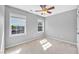 This bedroom has neutral paint, carpet, two windows, and a ceiling fan at 421 Gooseberry Dr, Holly Springs, NC 27540