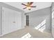 This bedroom has neutral paint, carpet, a ceiling fan, and a closet with bi-fold doors at 421 Gooseberry Dr, Holly Springs, NC 27540