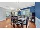 A dining room boasts hardwood floors, a dark wood table and six upholstered chairs at 421 Gooseberry Dr, Holly Springs, NC 27540