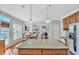 Bright kitchen with granite island, stainless appliances, and hardwood floors at 421 Gooseberry Dr, Holly Springs, NC 27540