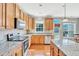 Updated kitchen with stainless steel appliances, granite countertops, and ample cabinet space at 421 Gooseberry Dr, Holly Springs, NC 27540