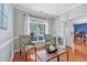 Bright and airy living room with two accent chairs, hardwood floors, and natural lighting at 421 Gooseberry Dr, Holly Springs, NC 27540