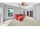 Bright living room with a red sectional couch, neutral walls, and a ceiling fan at 421 Gooseberry Dr, Holly Springs, NC 27540