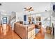 Bright living room with hardwood floors and views into the kitchen through pass-through windows at 421 Gooseberry Dr, Holly Springs, NC 27540