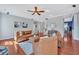 An expansive living room boasts a ceiling fan and warm-toned leather furniture set at 421 Gooseberry Dr, Holly Springs, NC 27540