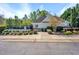 View of pool with pool house and surrounding landscaping at 421 Gooseberry Dr, Holly Springs, NC 27540