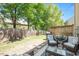 Fenced backyard with a patio, outdoor furniture, trimmed grass, and tall, mature shade trees at 4240 Camden Woods Ct, Raleigh, NC 27612