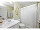 Clean bathroom featuring a toilet, vanity, shower-tub combination, and white shower curtain at 4240 Camden Woods Ct, Raleigh, NC 27612