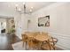 Dining area with wood table and chairs, decorative mirror, and elegant chandelier at 4240 Camden Woods Ct, Raleigh, NC 27612