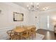 Inviting dining room with modern light fixture, hardwood floors, and an ornate decorative mirror at 4240 Camden Woods Ct, Raleigh, NC 27612