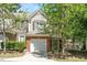 Charming two-story home boasts brick and siding, plus a one-car garage and inviting front entrance at 4240 Camden Woods Ct, Raleigh, NC 27612