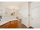 Open concept kitchen with stainless steel appliances, wood cabinets, and view to dining area at 4240 Camden Woods Ct, Raleigh, NC 27612