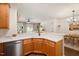 Kitchen with wood cabinets, stainless steel appliances, quartz countertop, and views to living space at 4240 Camden Woods Ct, Raleigh, NC 27612
