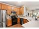 Bright kitchen features stainless steel appliances, quartz countertops, and wooden cabinets at 4240 Camden Woods Ct, Raleigh, NC 27612