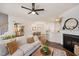 Bright living room features hardwood floors, a fireplace, bar seating, and an open concept to the dining room at 4240 Camden Woods Ct, Raleigh, NC 27612