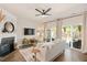 Cozy living room with fireplace, neutral sofa, and sliding glass doors to a patio at 4240 Camden Woods Ct, Raleigh, NC 27612