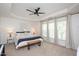 Spacious main bedroom boasts tray ceilings, neutral carpet, large windows, and a ceiling fan at 4240 Camden Woods Ct, Raleigh, NC 27612