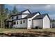 The modern two-story house features a black roof and gutters, plus a grill at 45 Hamilton Way, Youngsville, NC 27596