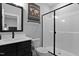 Bathroom with dark vanity, toilet and shower, and a world map wall decoration at 45 Hamilton Way, Youngsville, NC 27596