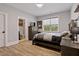 Bedroom with ensuite bathroom featuring a large bed, dresser, and natural light at 45 Hamilton Way, Youngsville, NC 27596