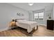 Cozy bedroom with hardwood floors, a queen-sized bed, neutral paint, and natural light from the window at 45 Hamilton Way, Youngsville, NC 27596