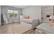 Bright bedroom featuring a trundle bed, area rug, shelving unit, and large window with natural light at 45 Hamilton Way, Youngsville, NC 27596