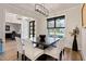 Modern dining room with a dark table, white chairs, stylish lighting, and view to the office at 45 Hamilton Way, Youngsville, NC 27596