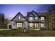Charming two-story home with a covered front porch, showcasing its inviting curb appeal at dusk at 45 Hamilton Way, Youngsville, NC 27596