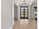 Elegant foyer with hardwood floors, natural light, and a stylish glass front door at 45 Hamilton Way, Youngsville, NC 27596