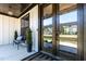 Inviting front porch featuring a bench, stylish lighting, and a modern glass-paneled front door at 45 Hamilton Way, Youngsville, NC 27596