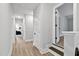 Bright hallway with wood floors, white trim, and doors leading to various rooms in the house at 45 Hamilton Way, Youngsville, NC 27596