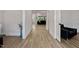 Bright and airy hallway with beautiful flooring and neutral walls, showcasing the home's open layout at 45 Hamilton Way, Youngsville, NC 27596