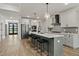 Spacious kitchen with large island, counter seating, stainless steel appliances, and modern lighting at 45 Hamilton Way, Youngsville, NC 27596