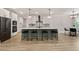 Modern kitchen with white cabinets, a large island with seating, and stainless steel appliances at 45 Hamilton Way, Youngsville, NC 27596