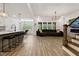 Open-concept living area featuring a large island, modern lighting, and a cozy seating arrangement at 45 Hamilton Way, Youngsville, NC 27596