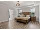 Bright main bedroom featuring wood flooring, tray ceiling and ensuite bathroom at 45 Hamilton Way, Youngsville, NC 27596