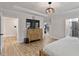 Main bedroom with wood flooring, tray ceiling, dresser and walk in closet at 45 Hamilton Way, Youngsville, NC 27596